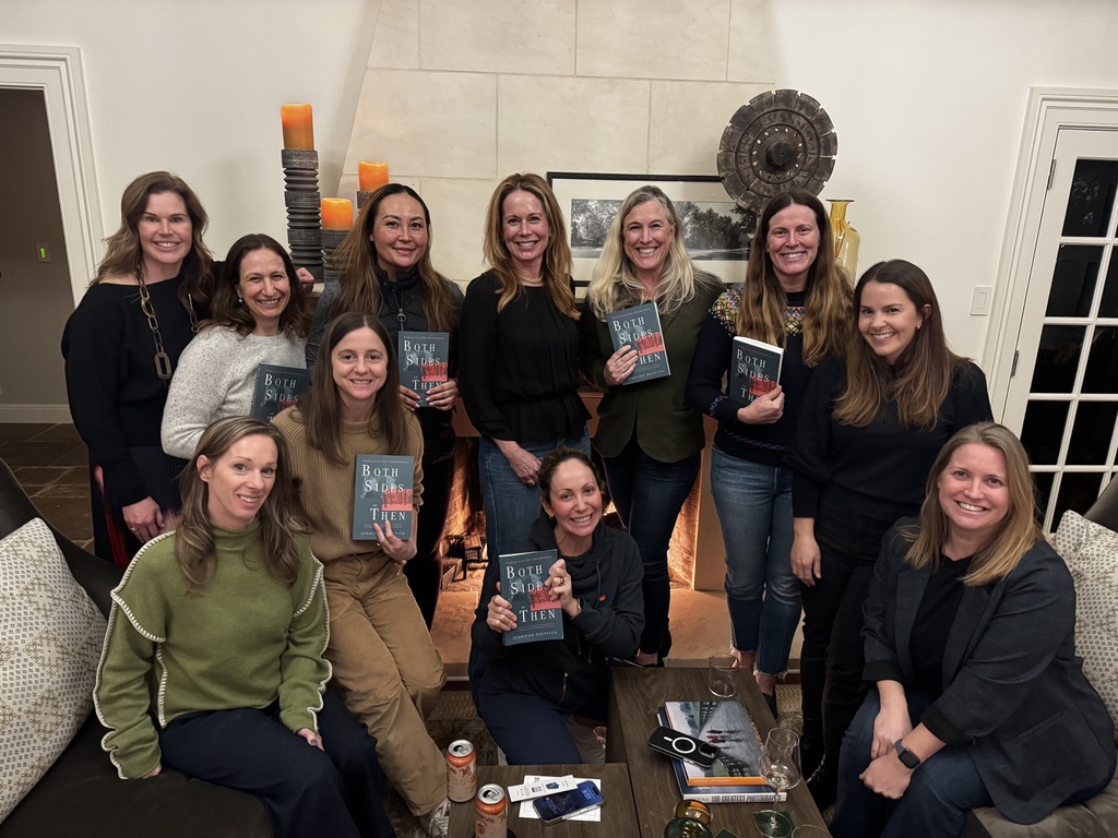 A book club gathered in a living room with Jennifer.